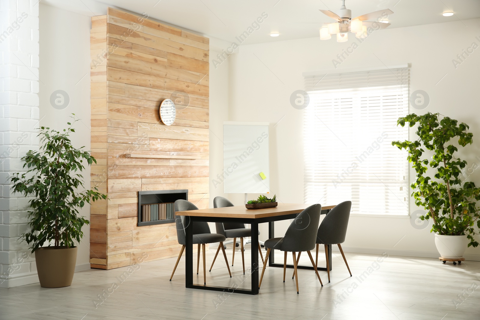 Photo of Modern meeting room interior with large table and chairs