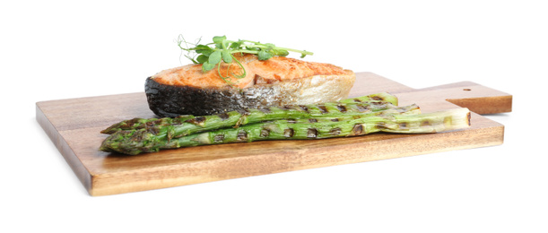Photo of Tasty salmon steak with asparagus and sprouts isolated on white