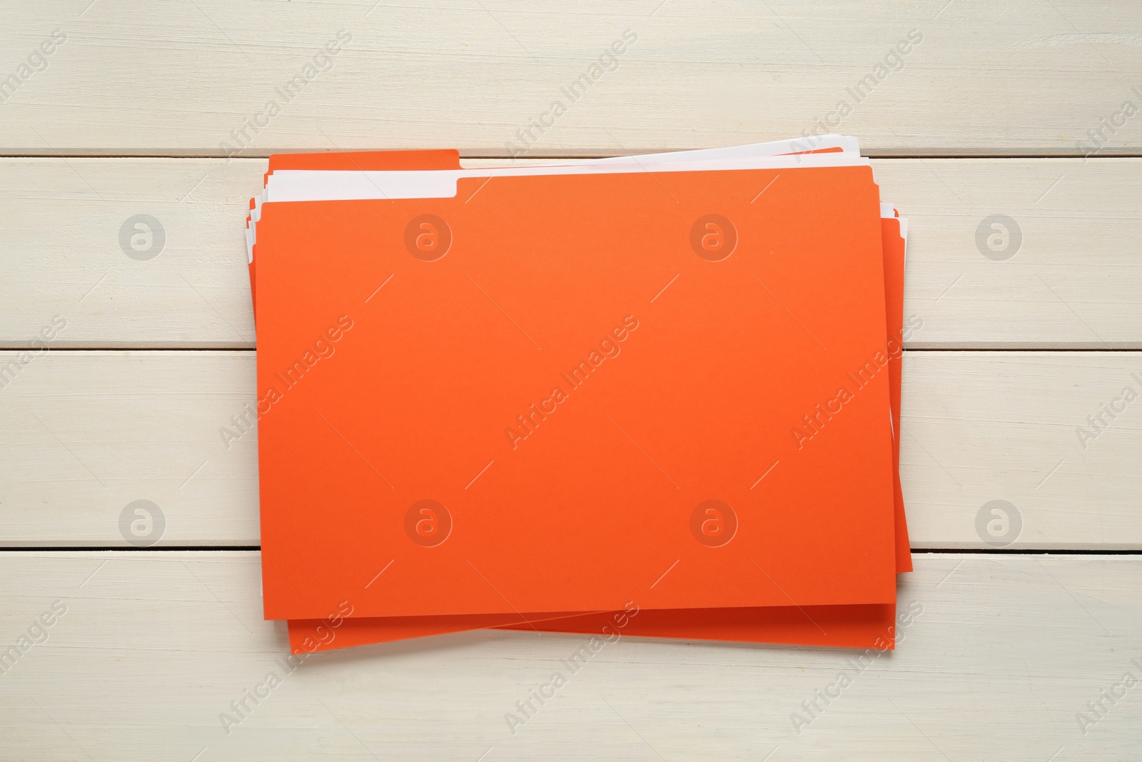 Photo of Orange files with documents on white wooden table, top view