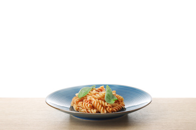 Photo of Delicious fusilli pasta with tomato sauce on wooden table