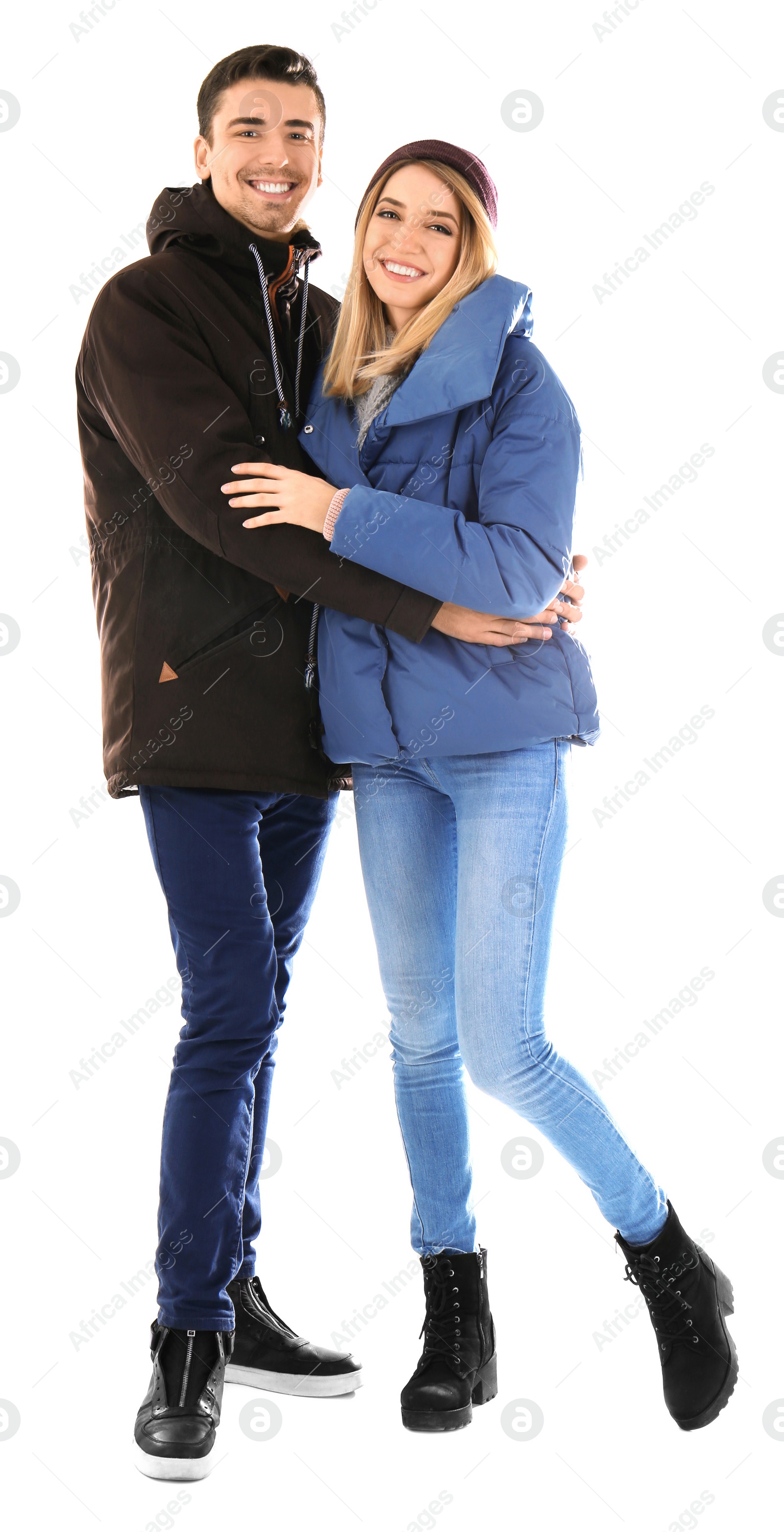 Photo of Young couple in warm clothing on white background. Ready for winter vacation