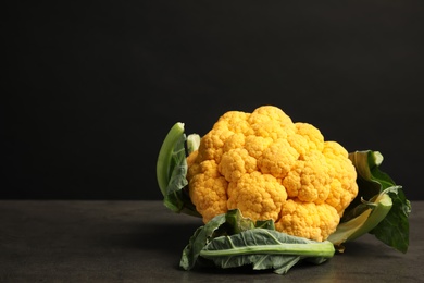 Yellow cauliflower cabbage on table against black background. Healthy food