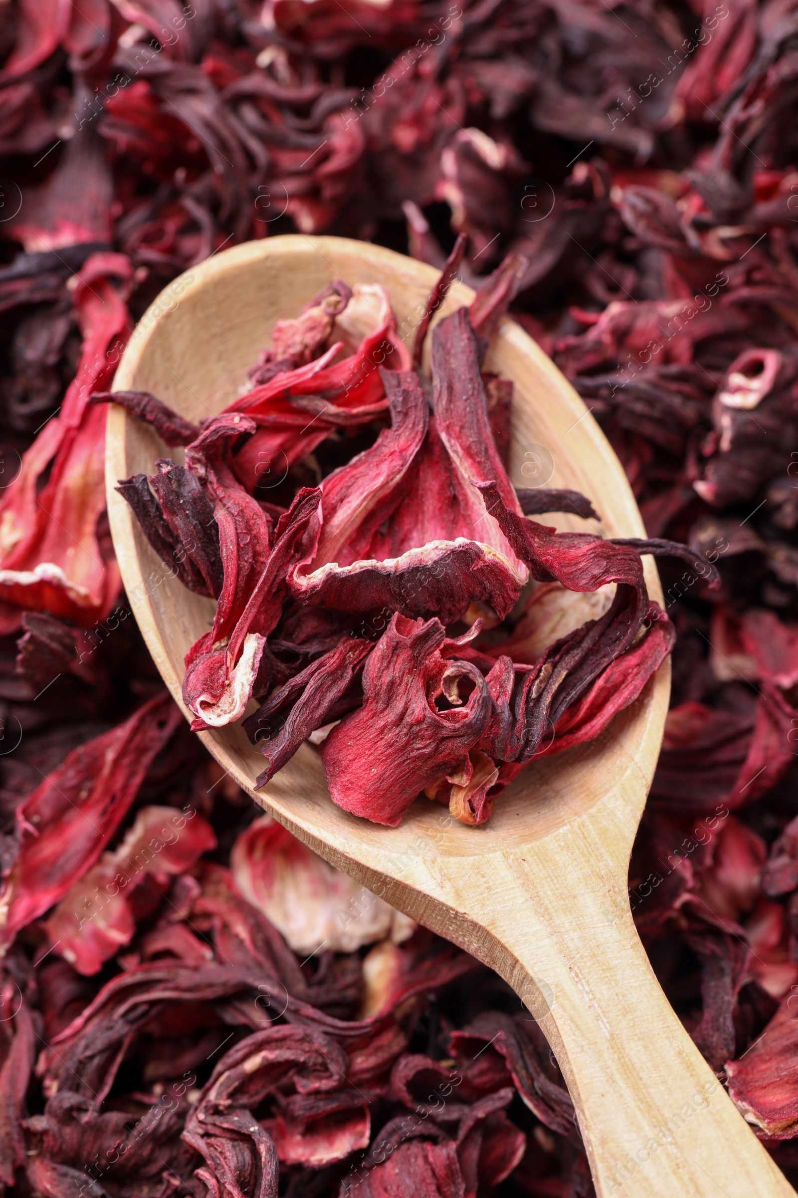 Photo of Wooden spoon with dry hibiscus tea, closeup