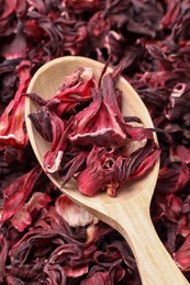 Wooden spoon with dry hibiscus tea, closeup