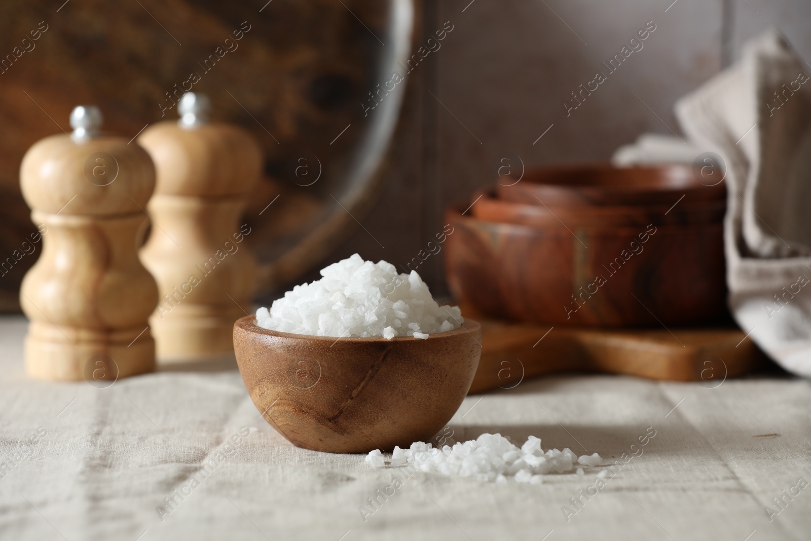 Photo of Organic salt in wooden bowl on table