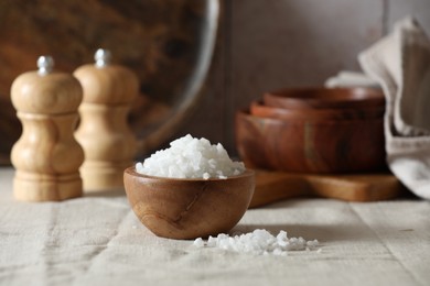 Photo of Organic salt in wooden bowl on table