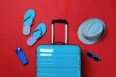 Photo of Flat lay composition with stylish suitcase and accessories on color background