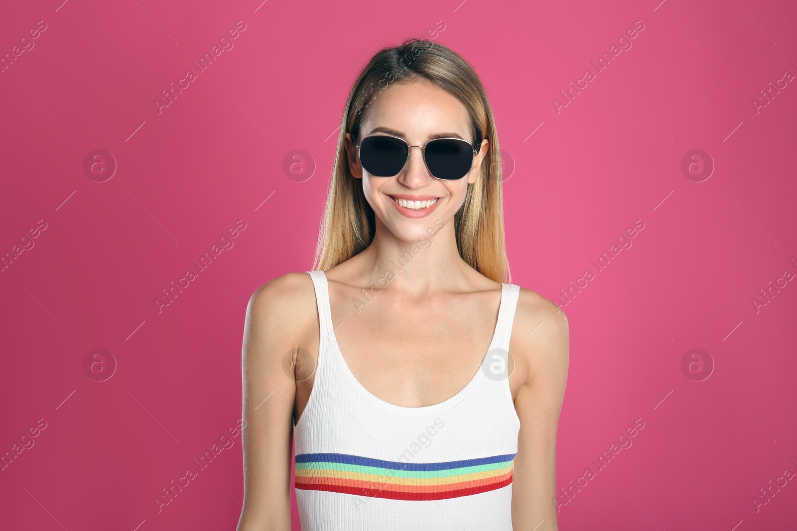 Photo of Beautiful woman in stylish sunglasses on pink background