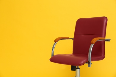 Modern office chair on yellow background. Space for text