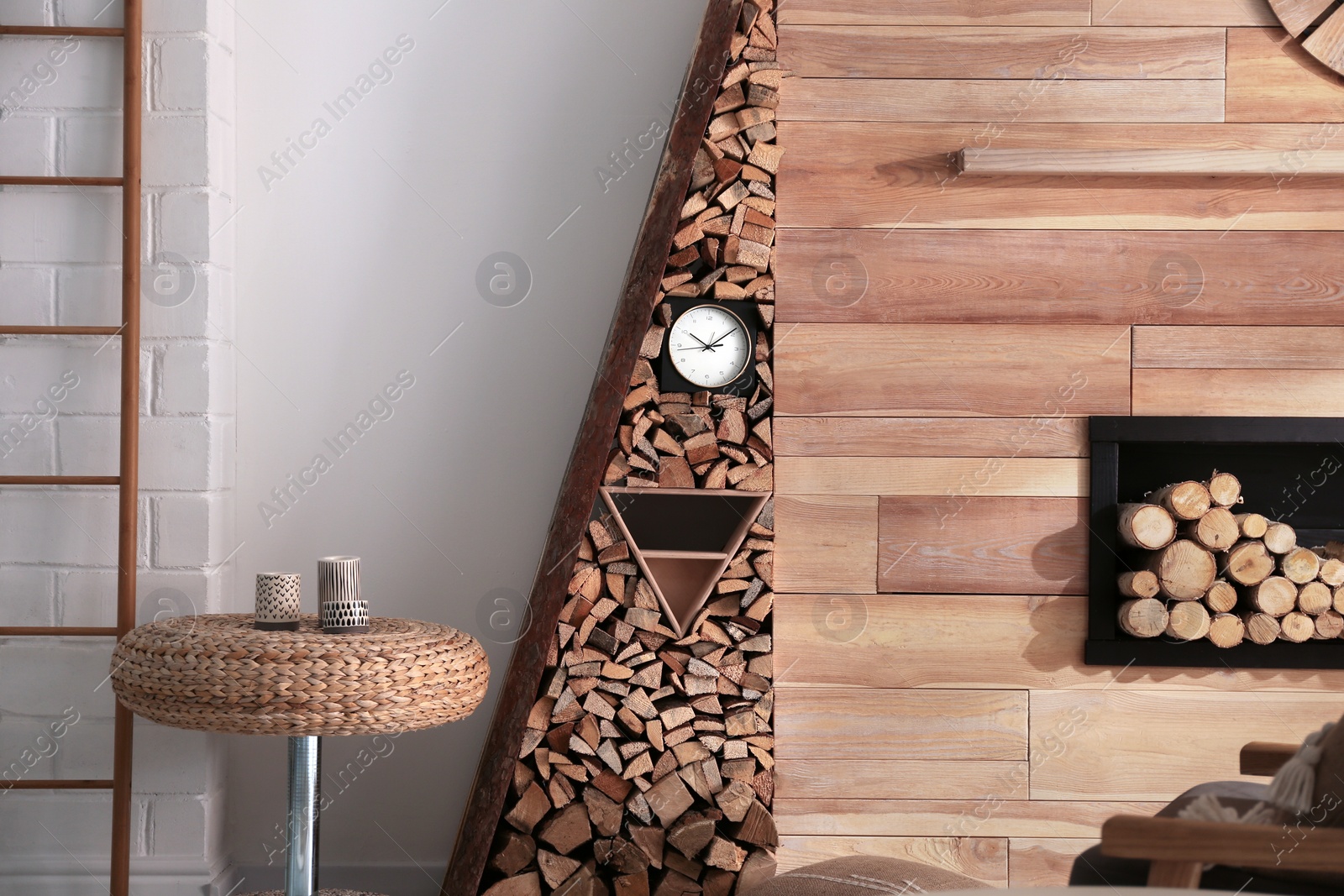 Photo of Decorative fireplace with stacked wood in cozy living room interior