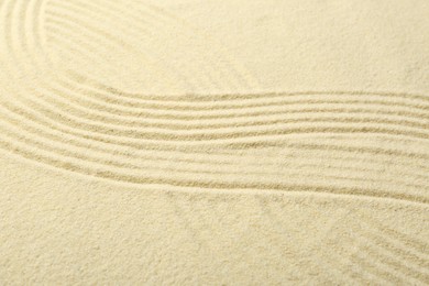 Zen rock garden. Wave pattern on beige sand