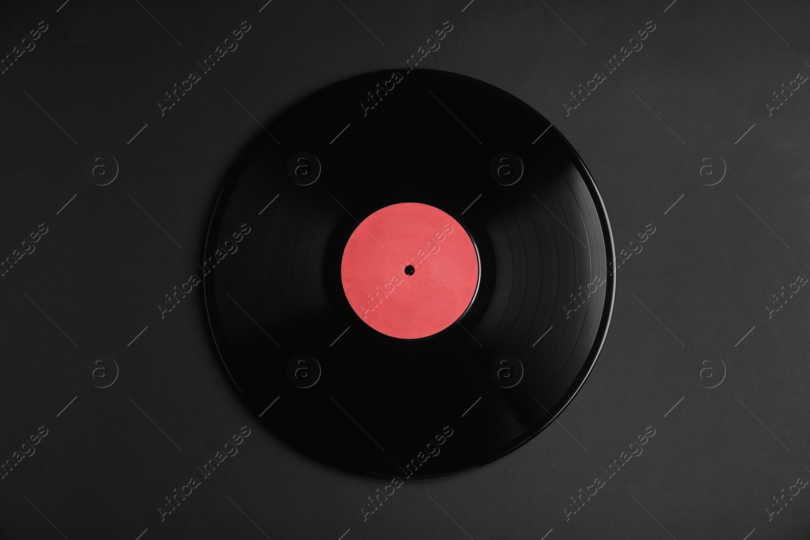 Photo of Vintage vinyl record on black background, top view