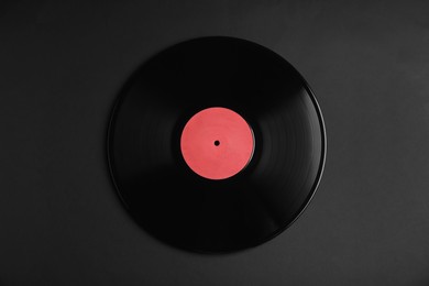 Photo of Vintage vinyl record on black background, top view