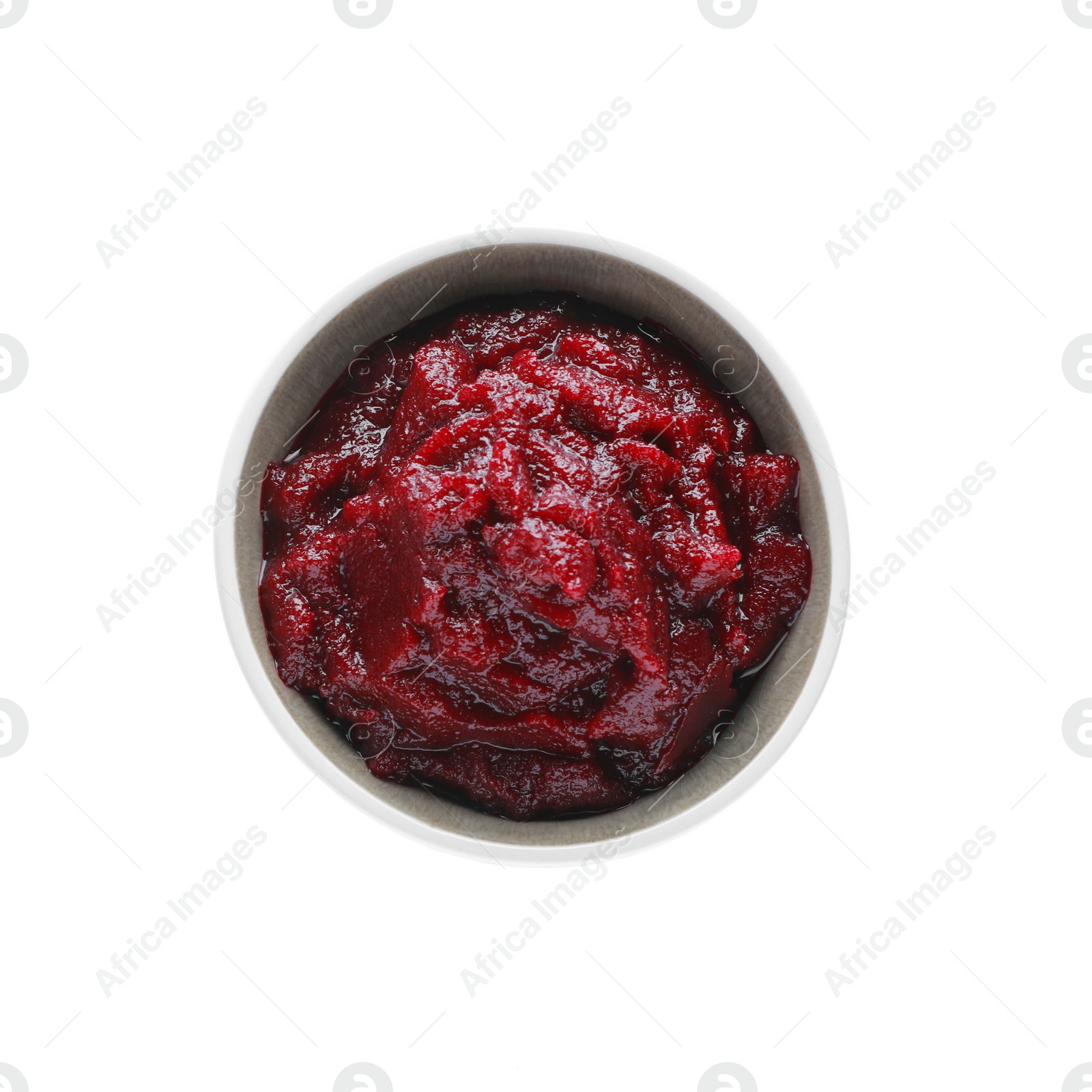 Photo of Delicious beetroot puree in bowl isolated on white, top view. Healthy food