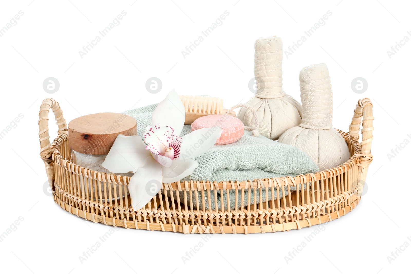 Photo of Spa composition. Towel, herbal massage bags, sea salt, soap and beautiful flower on white background