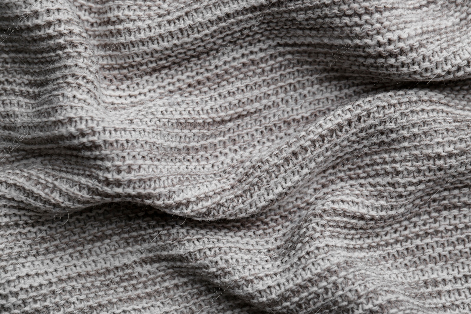 Photo of Beautiful grey knitted fabric as background, top view