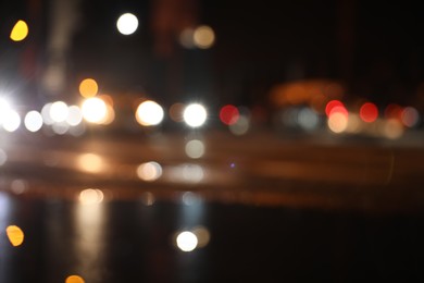 Photo of Blurred view of cityscape with bokeh effect. Night life