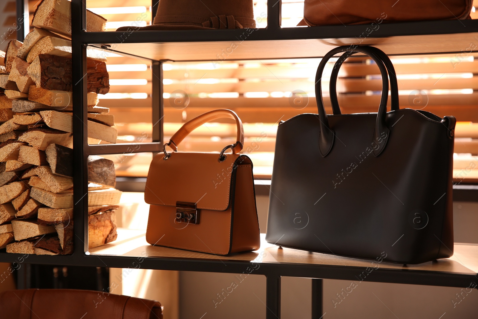 Photo of Stylish woman's bags on shelf in boutique