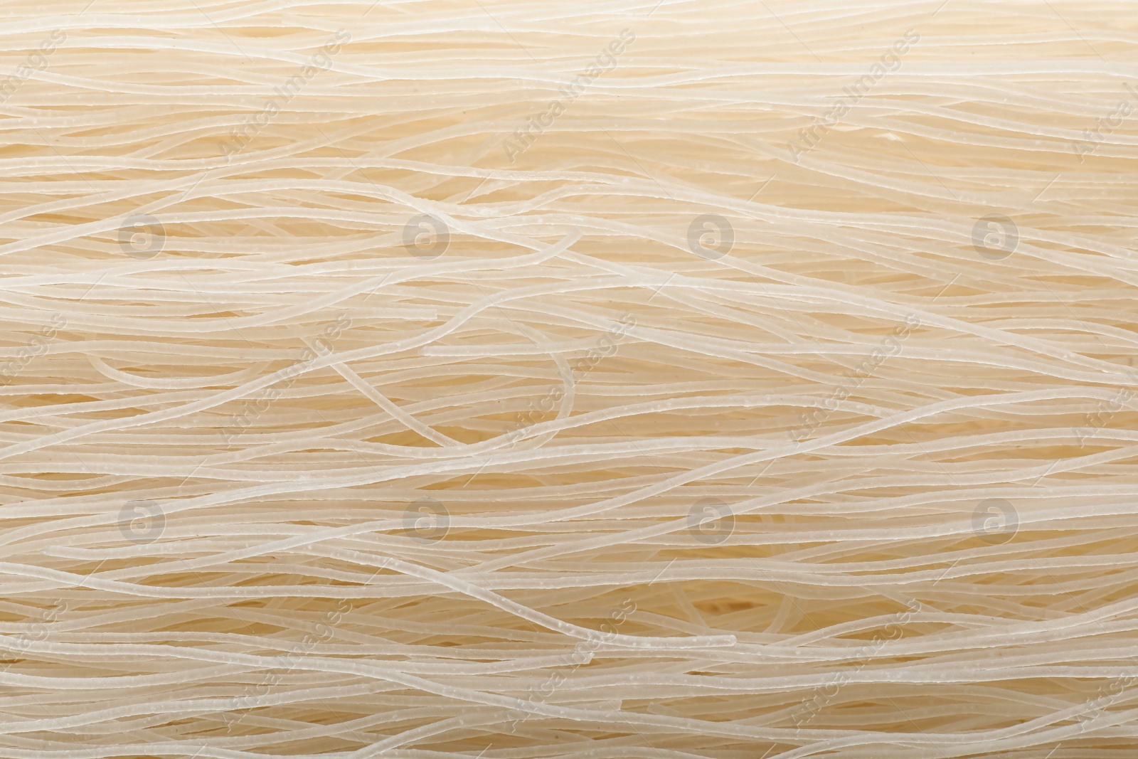 Photo of Raw rice noodles as background, closeup view