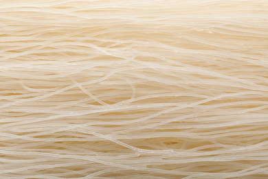 Photo of Raw rice noodles as background, closeup view