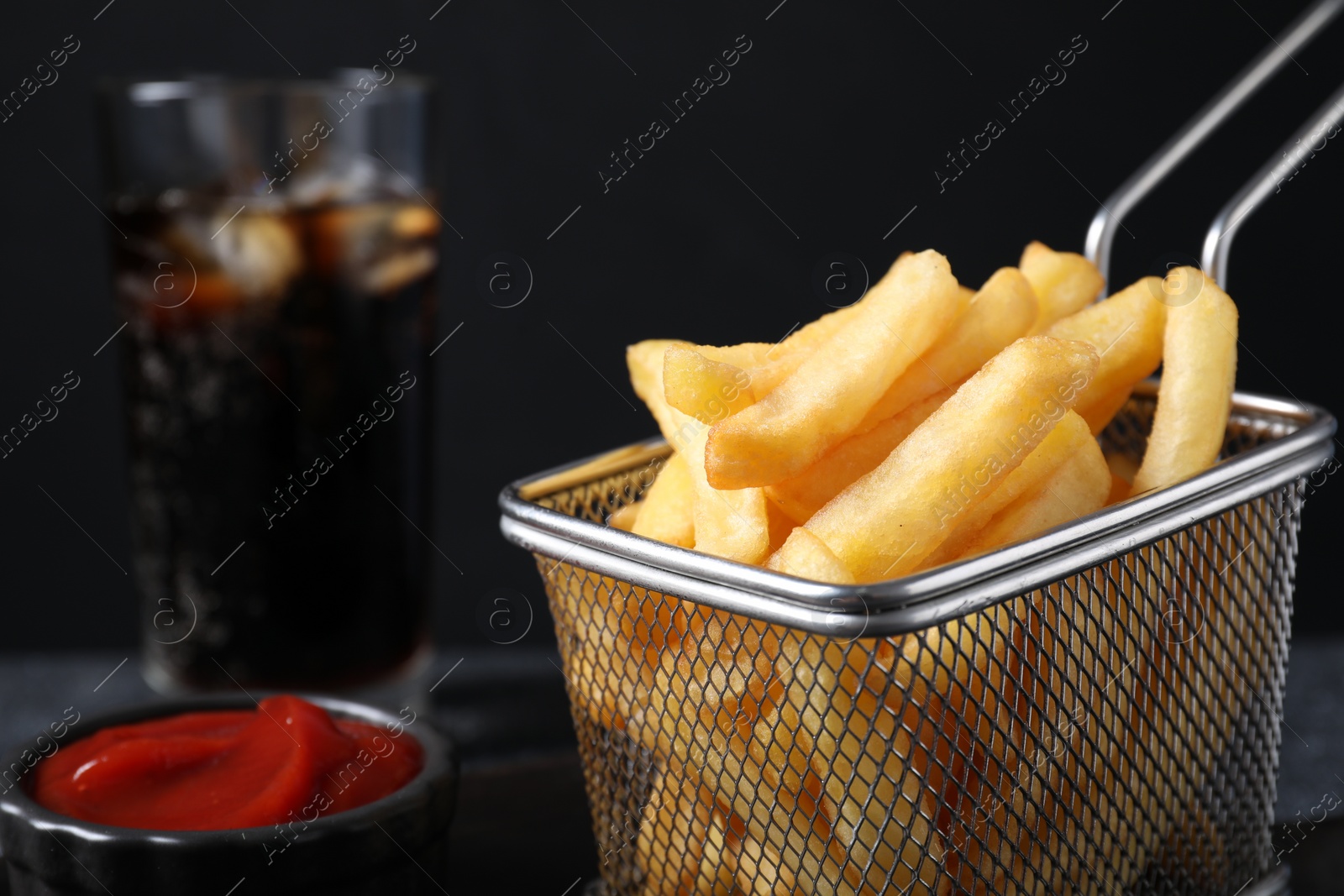 Photo of Metal basket with tasty French fries, closeup. Space for text