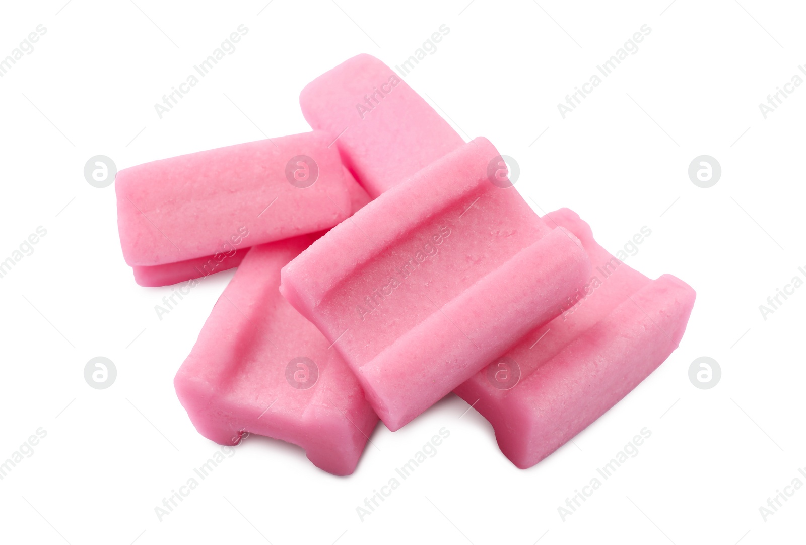 Photo of Many tasty pink chewing gums on white background