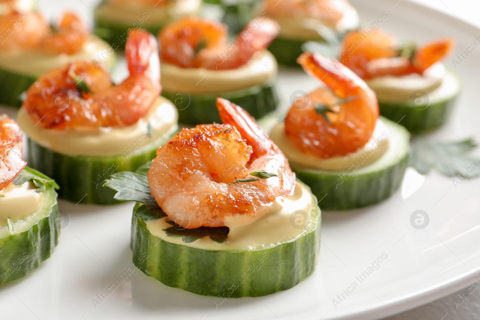 Photo of Delicious snacks with shrimp on plate, closeup