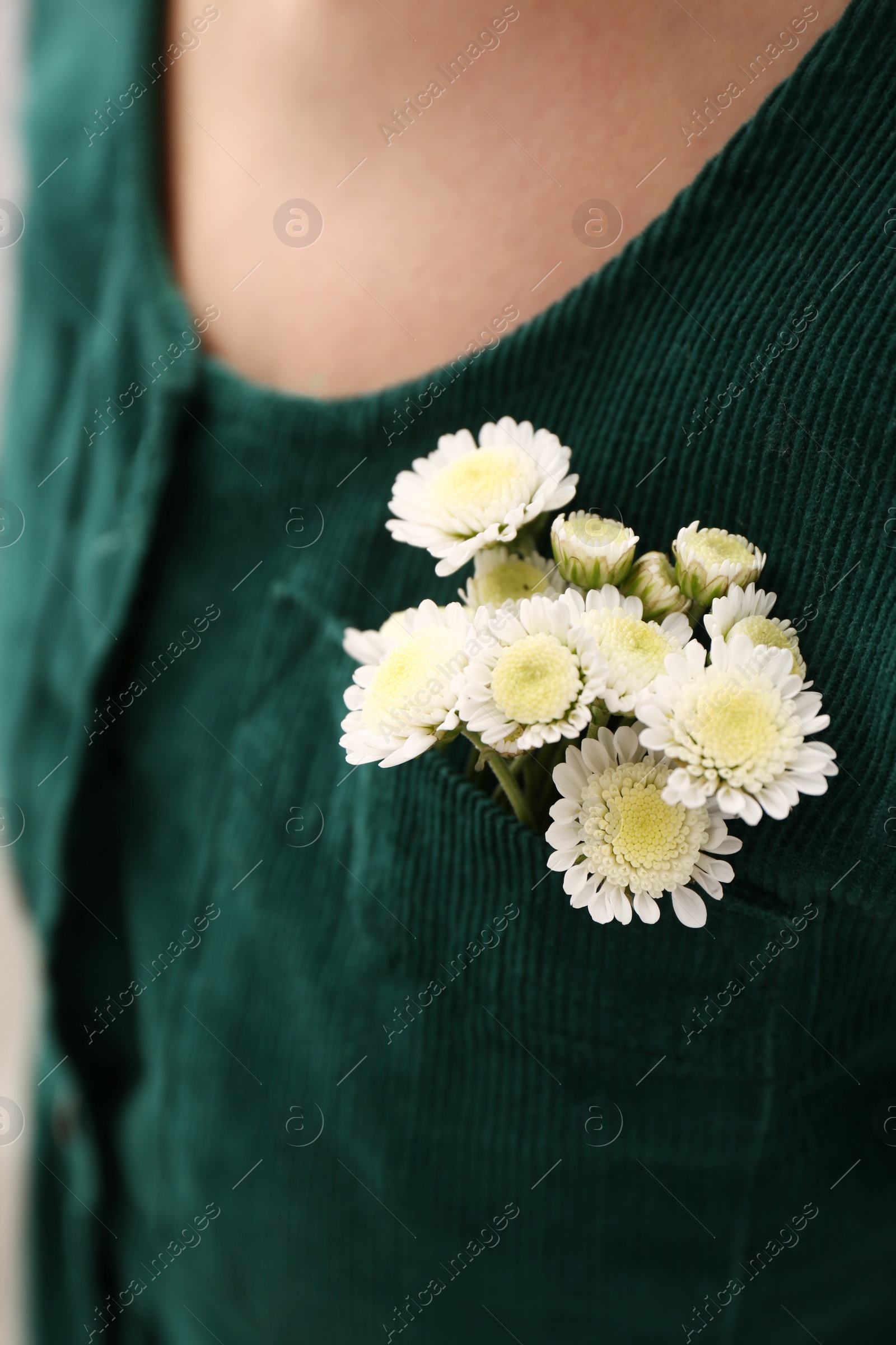 Photo of Woman wearing shirt with flowers in pocket, closeup