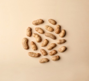 Photo of Composition with peanuts on color background, top view