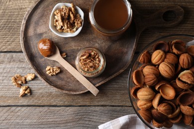 Making walnut shaped cookies. Cooked dough, caramelized condensed milk and nuts on wooden table, flat lay