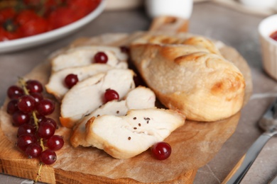 Tasty cooked chicken fillet served on grey table, closeup. Healthy meals from air fryer