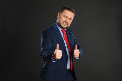 Photo of Portrait of happy mature man on black background