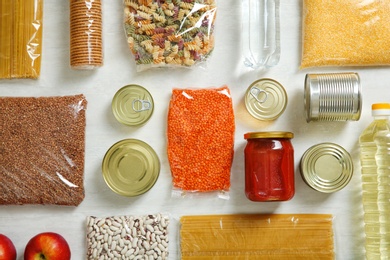 Photo of Many different products on white wooden background, flat lay. Food donation