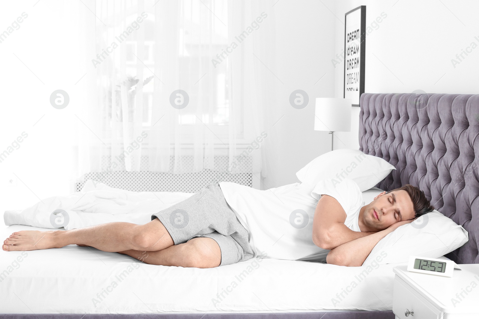 Photo of Young man sleeping in bed at home