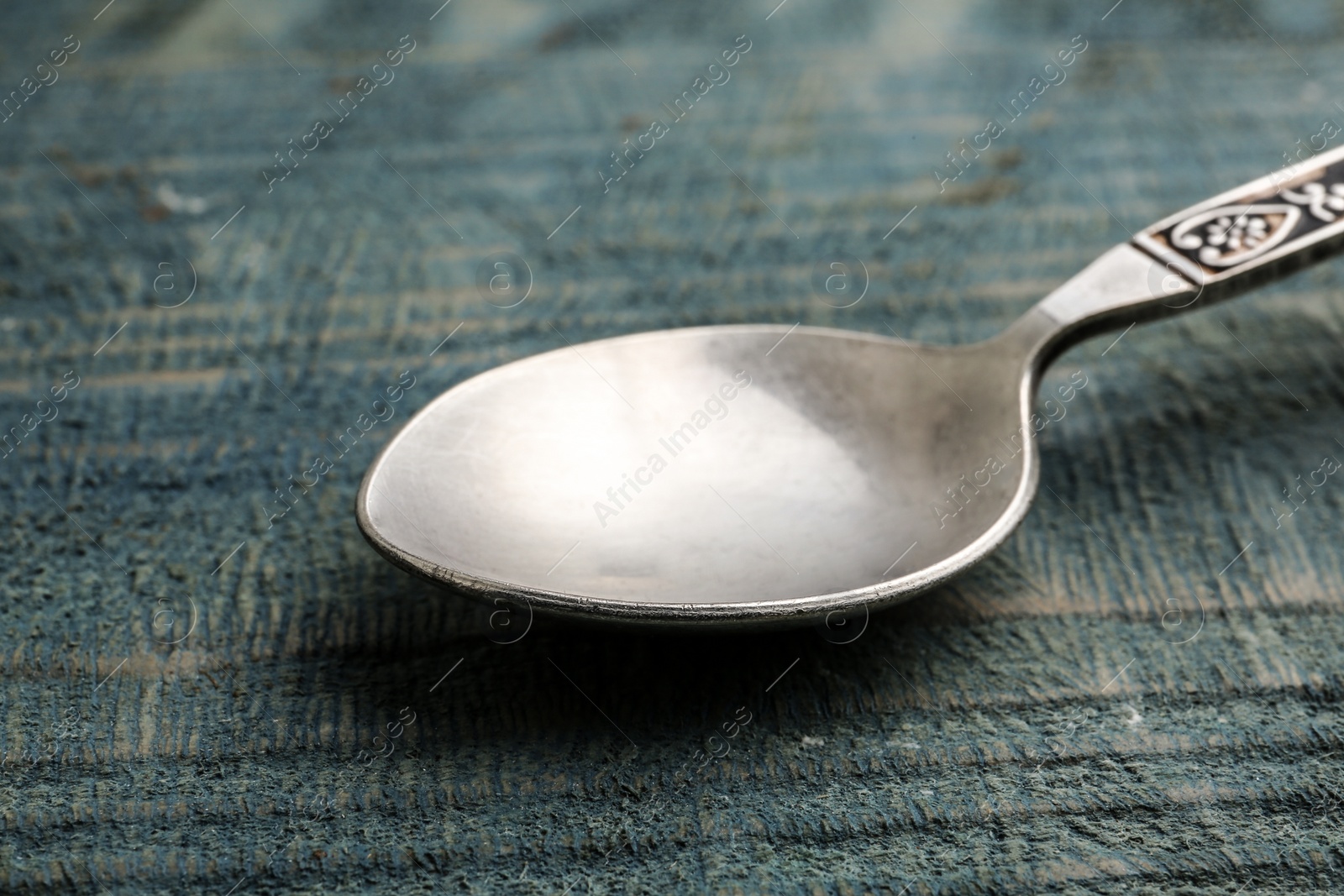 Photo of Clean vintage tea spoon on wooden background, closeup