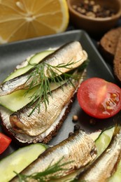 Photo of Delicious sandwiches with sprats, cucumber and dill served on plate, closeup