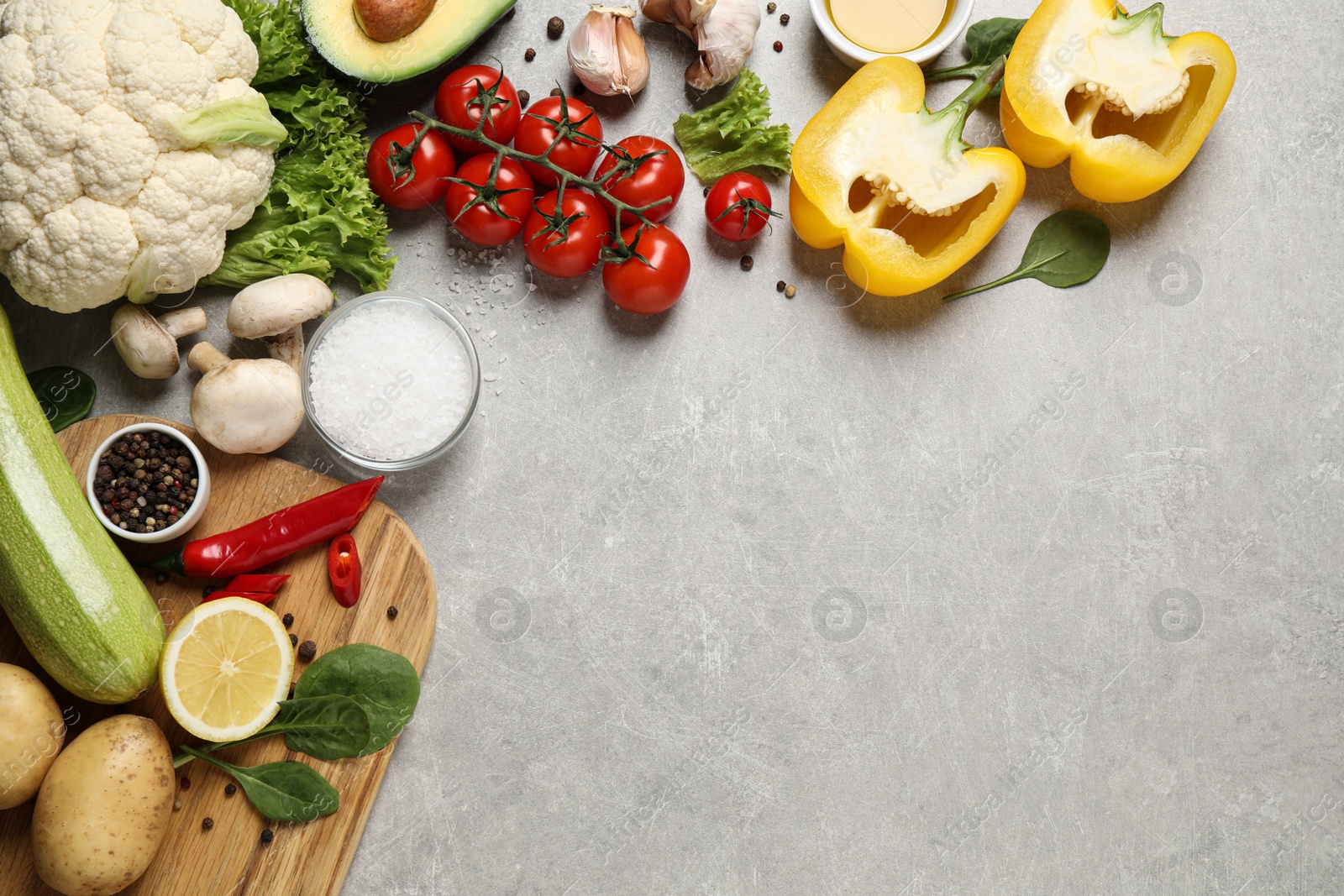 Photo of Flat lay composition with fresh products on light grey table,  space for text. Healthy cooking