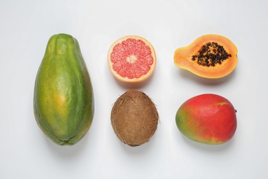 Photo of Fresh ripe papaya and other fruits on white background, top view