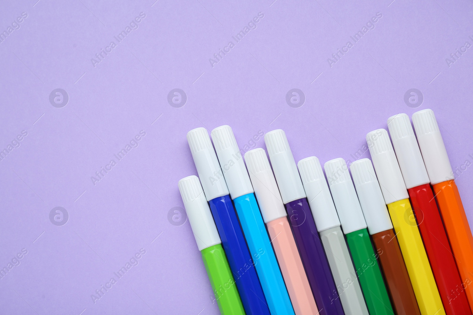 Photo of Different colorful markers on light background, flat lay. Space for text