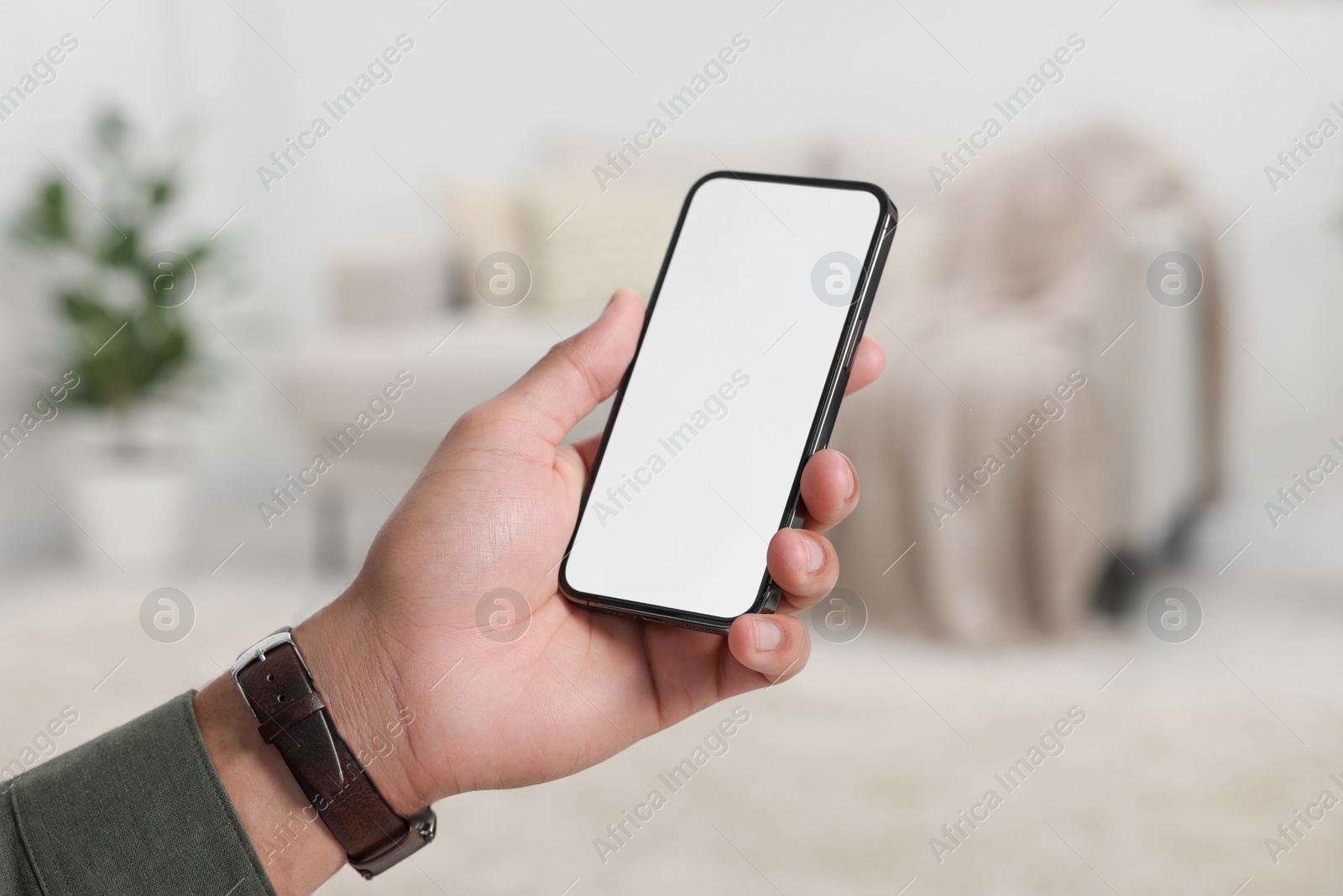 Photo of Man using modern mobile phone indoors, closeup