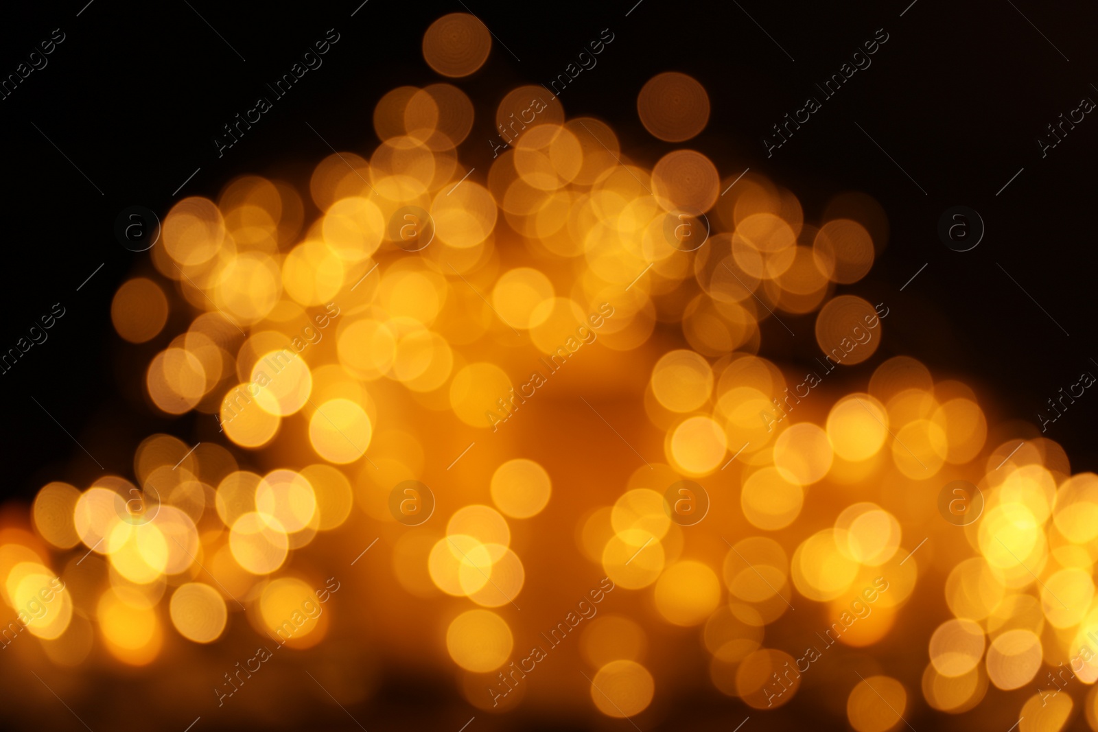 Photo of Gold glitter with bokeh effect on dark background