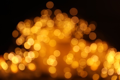 Photo of Gold glitter with bokeh effect on dark background