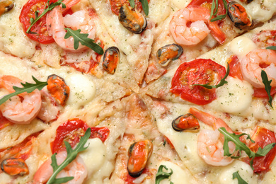 Photo of Delicious seafood pizza as background, closeup view