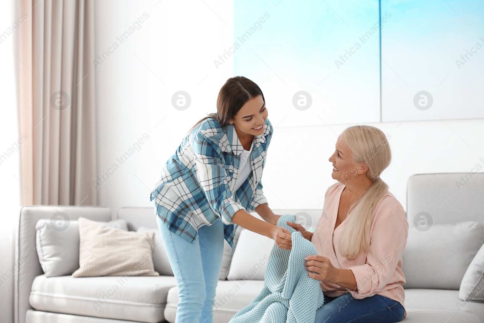 Photo of Daughter taking care of her mother at home. Help concept