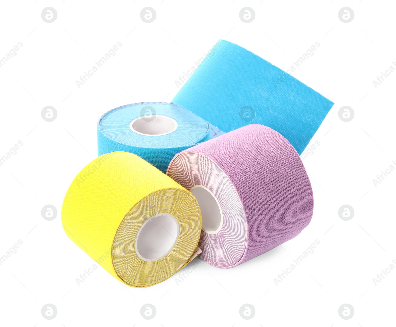 Photo of Many bright kinesio tape in rolls on white background