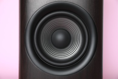 Photo of One wooden sound speaker on pink background, closeup