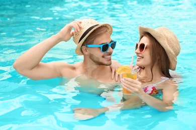 Young couple in pool on sunny day