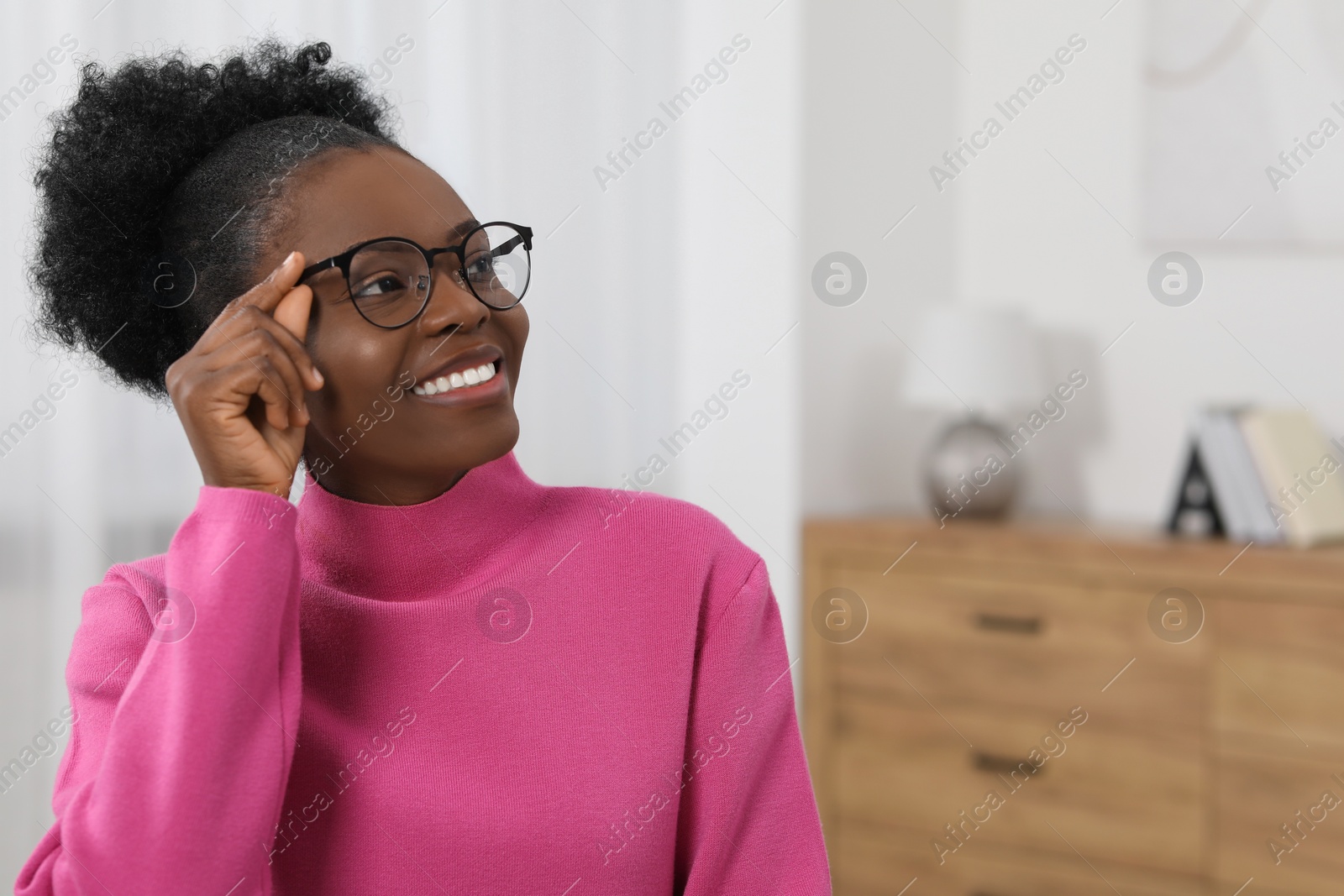 Photo of Portrait of beautiful young woman in eyeglasses indoors. Space for text