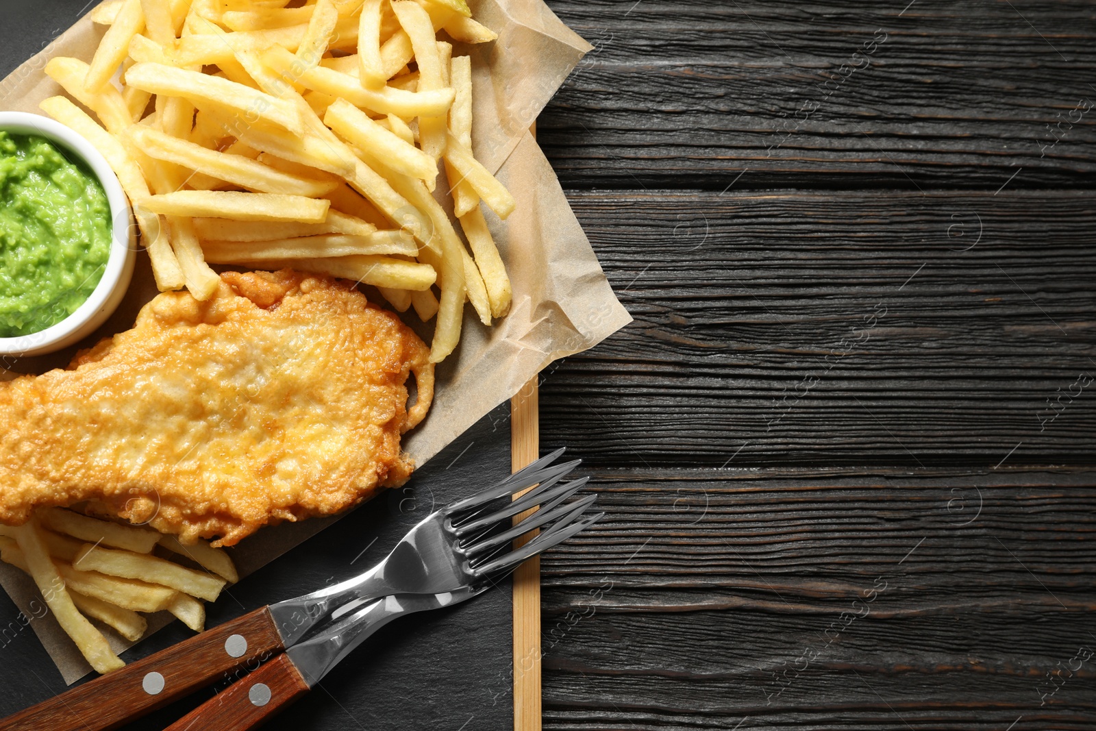 Photo of British Traditional Fish and potato chips on wooden background, top view. Space for text