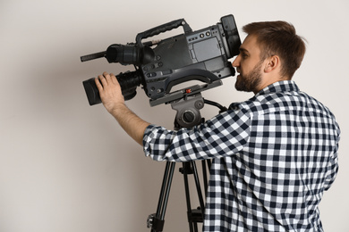 Photo of Operator with professional video camera on white background